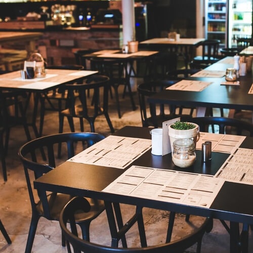 A Restaurant With Menus On Tables