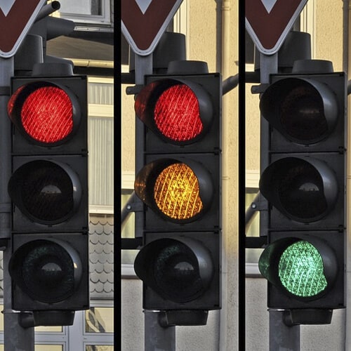 Three Traffic Lights With Different Lights Showing
