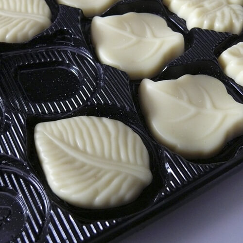 White Chocolates Shaped Like Leaves In Plastic Packaging