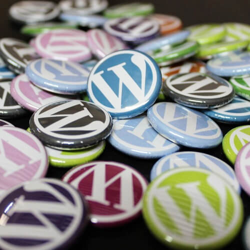 Multicoloured Badges With The WordPress Logo On Them