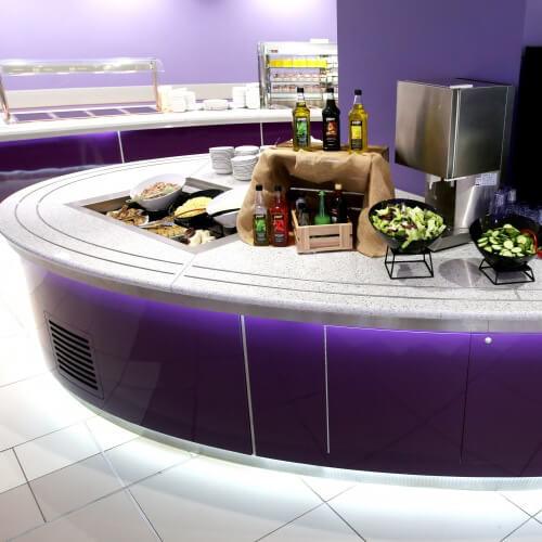 A Purple Buffett Stand With Food In Bowls