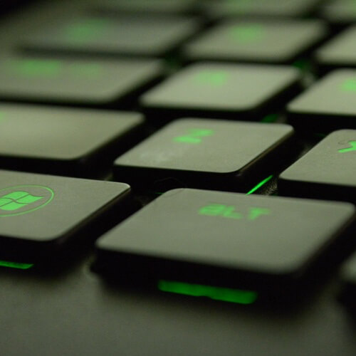 A Zoomed In Keyboard With Green Letters