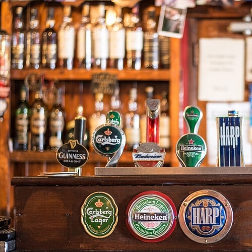 A Pub Bar With Alcoholic Drink Brands On The Pumps