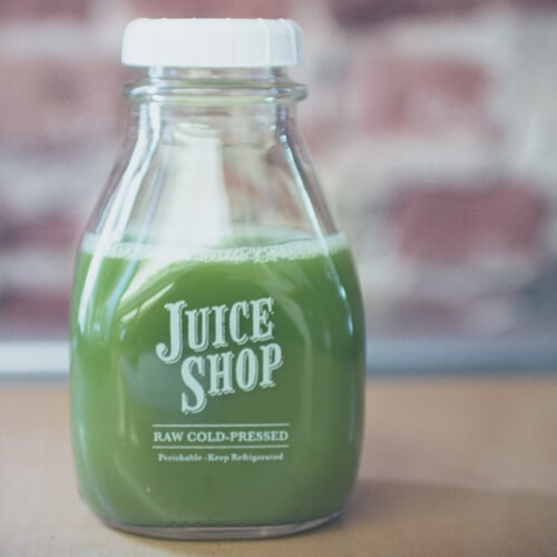 A Juice Shop Bottle Containing A Green Drink