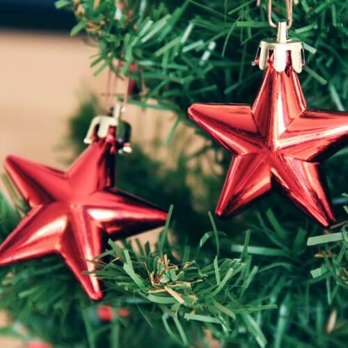 A Christmas Tree With Two Red Star Ornaments