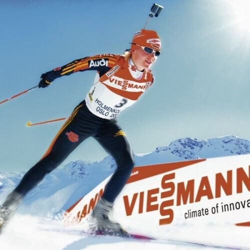 A Skier Going Past A Viessmann Sign