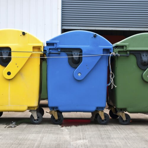 Three Large Bins In Green, Blue And Yellow