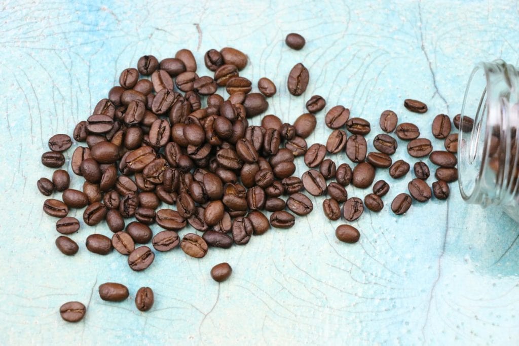 A Fallen Over Jar With Coffee Beans Spilling Out