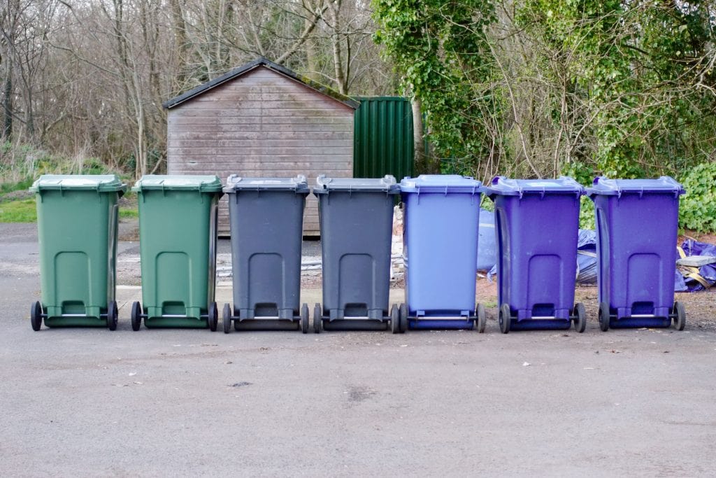 Different Coloured Bins Lined Up In A Row