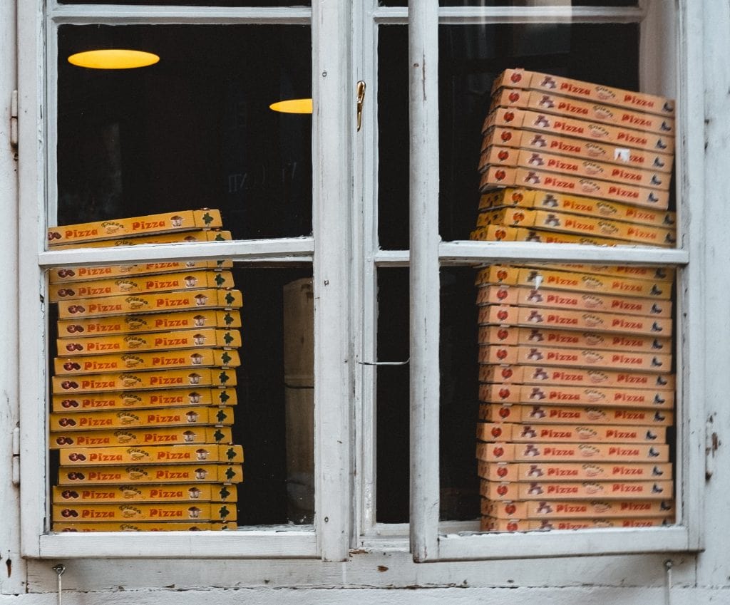 Two Open Windows Containing Stacks Of Pizza Boxes